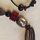 Glass, stone, bone on adjustable leather cord, 20 to 28